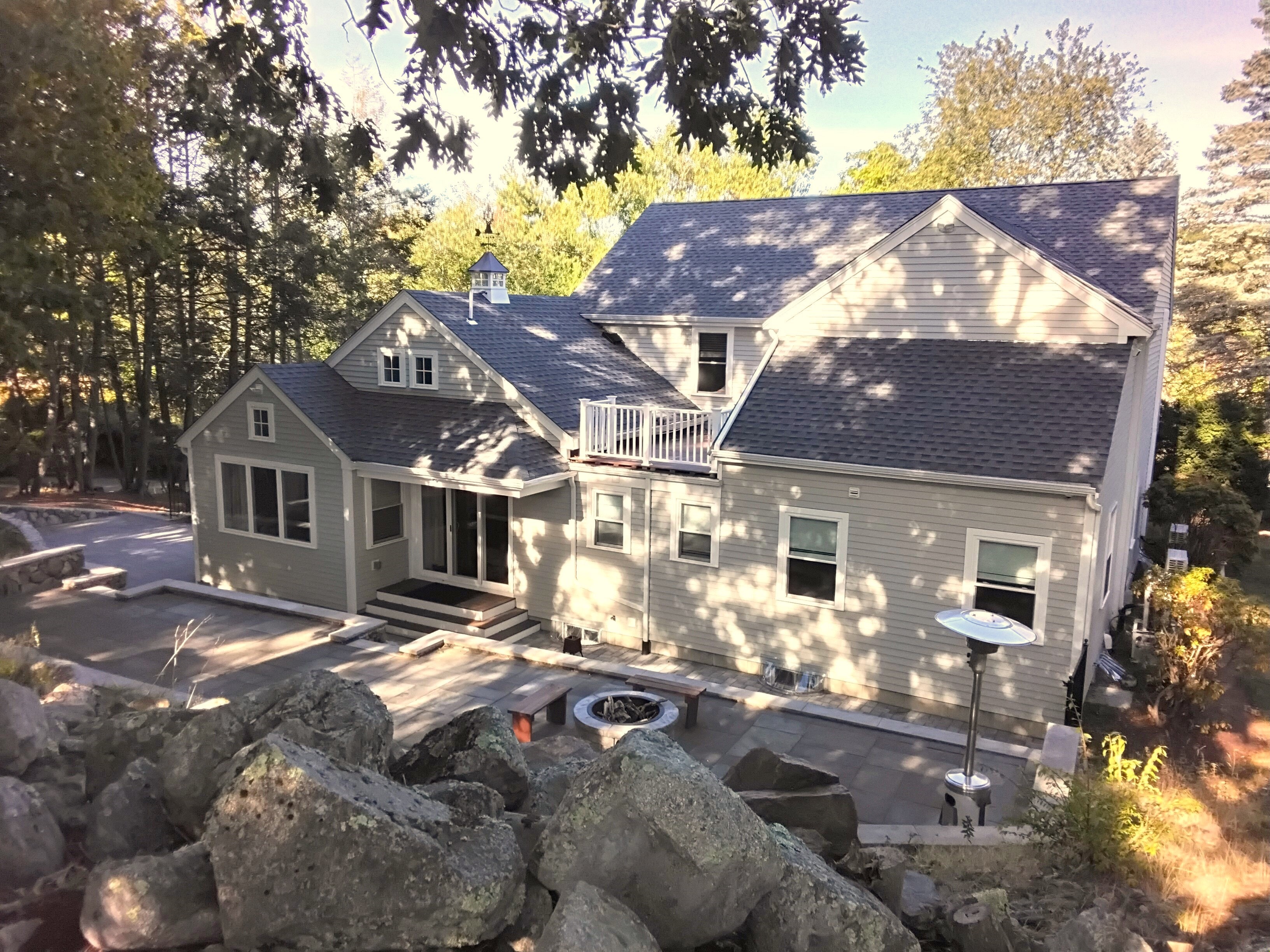 Colonial Home, Lexington — aerial rear view with a full-width addition and the existing patio