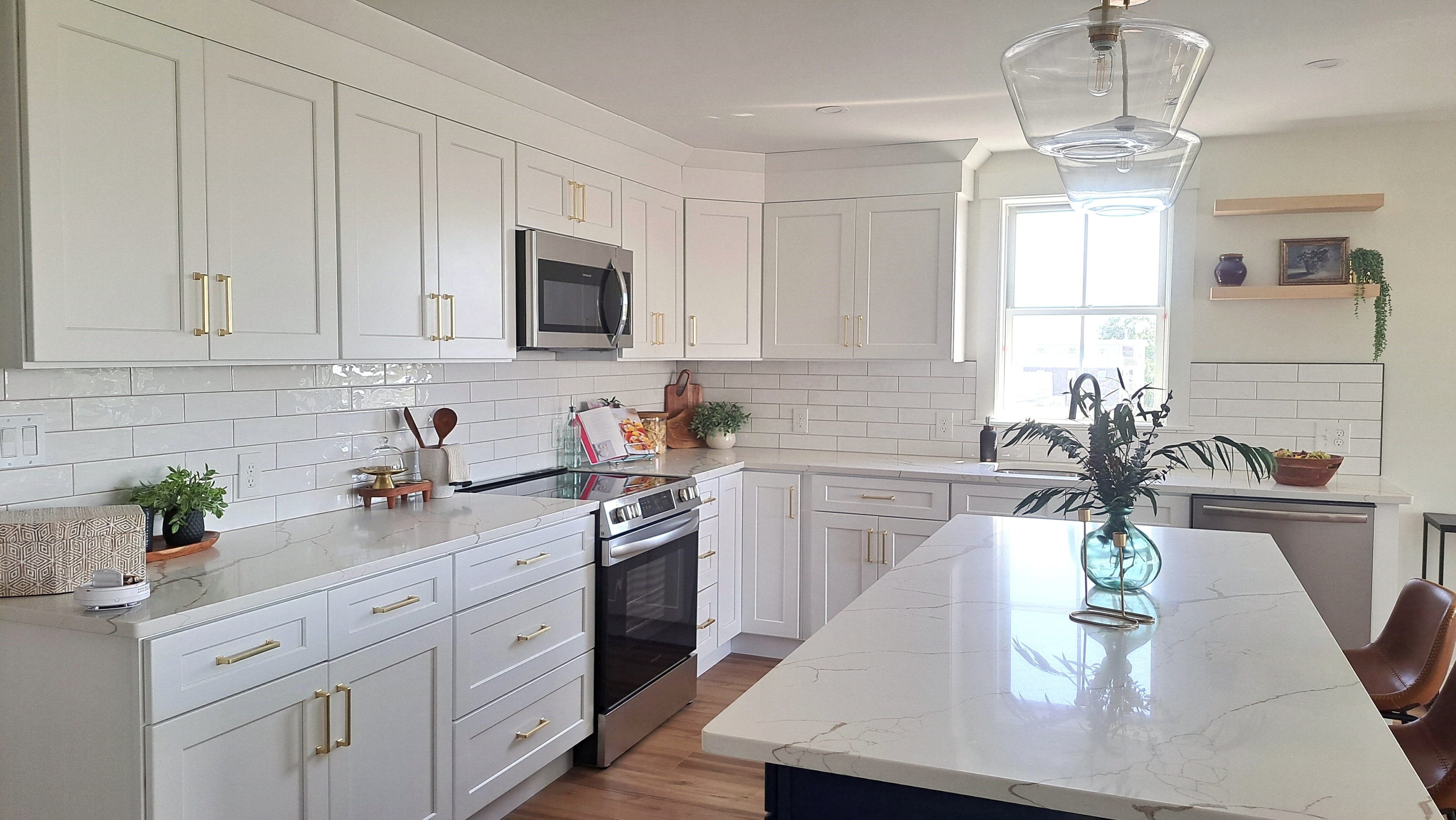 Kitchen with white cabinetry and marble countertops